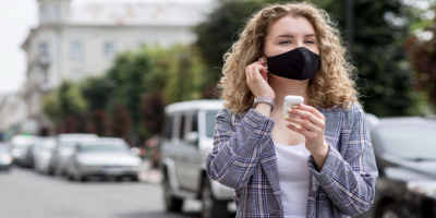 apre il dettaglio dell'articolo:ragazza in città che si protegge naso, bocca e orecchie